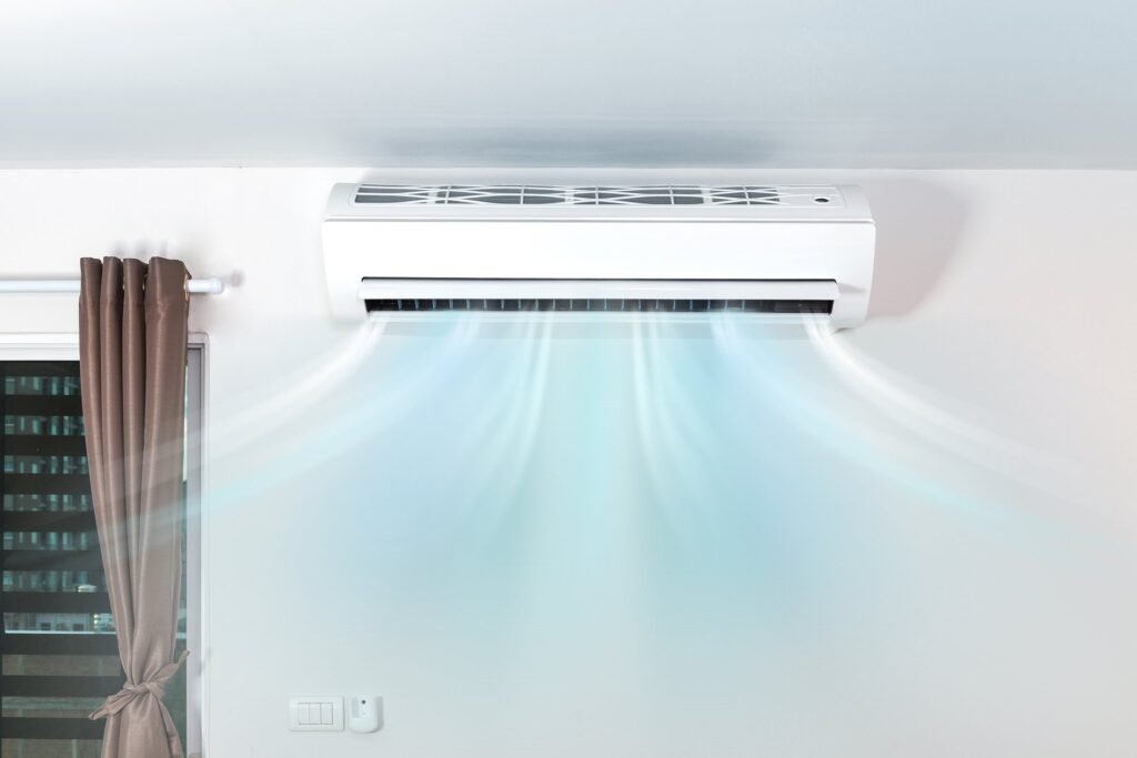 Wall unit above a window with cool air flowing into the room
