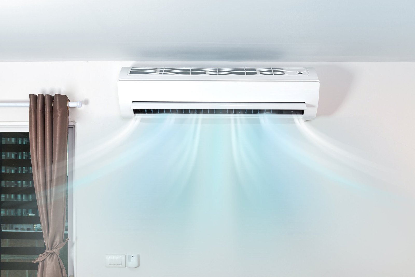Wall unit above a window with cool air flowing into the room