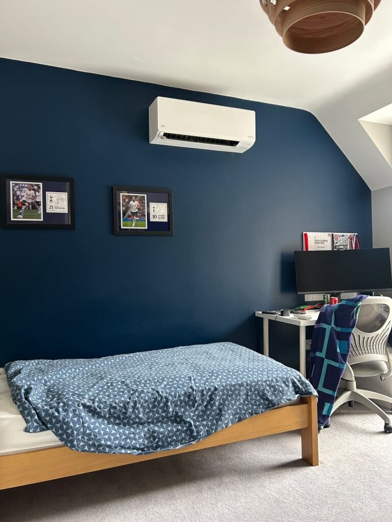Wall unit in a blue loft bedroom with a desk